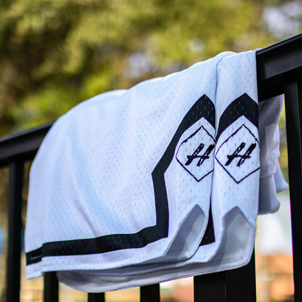 Pure White Board Member Shorts is now available at our store with an inside draw string and light mesh. It features a pitch black line surrounding the bottom of the shorts with our signature H logo stitched on encapsulated by a neat sable diamond. 