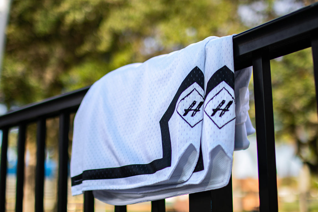 Pure White Board Member Shorts is now available at our store with an inside draw string and light mesh. It features a pitch black line surrounding the bottom of the shorts with our signature H logo stitched on encapsulated by a neat sable diamond. 